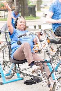 A happy participant on a recumbent bike, generating power.  © Alston Co. Photo